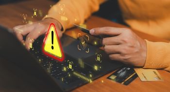 Man on laptop with icons of cybersecurity warnings.